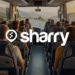 назва компанії Sharry на фоні салона автобусу, в якому сидять люди